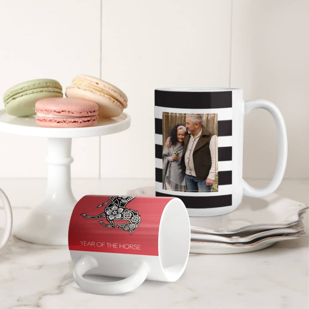 two mugs on table with macaroons