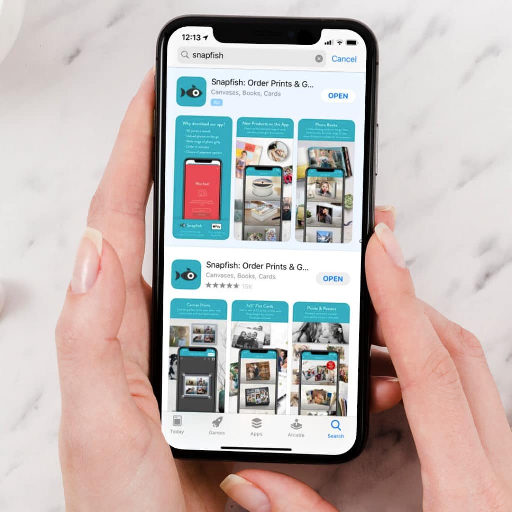 iphone x showing screen of snapfish app in appstore