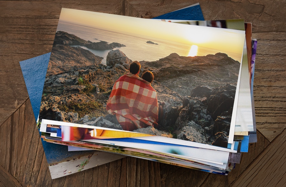 stack of prints on wooden table