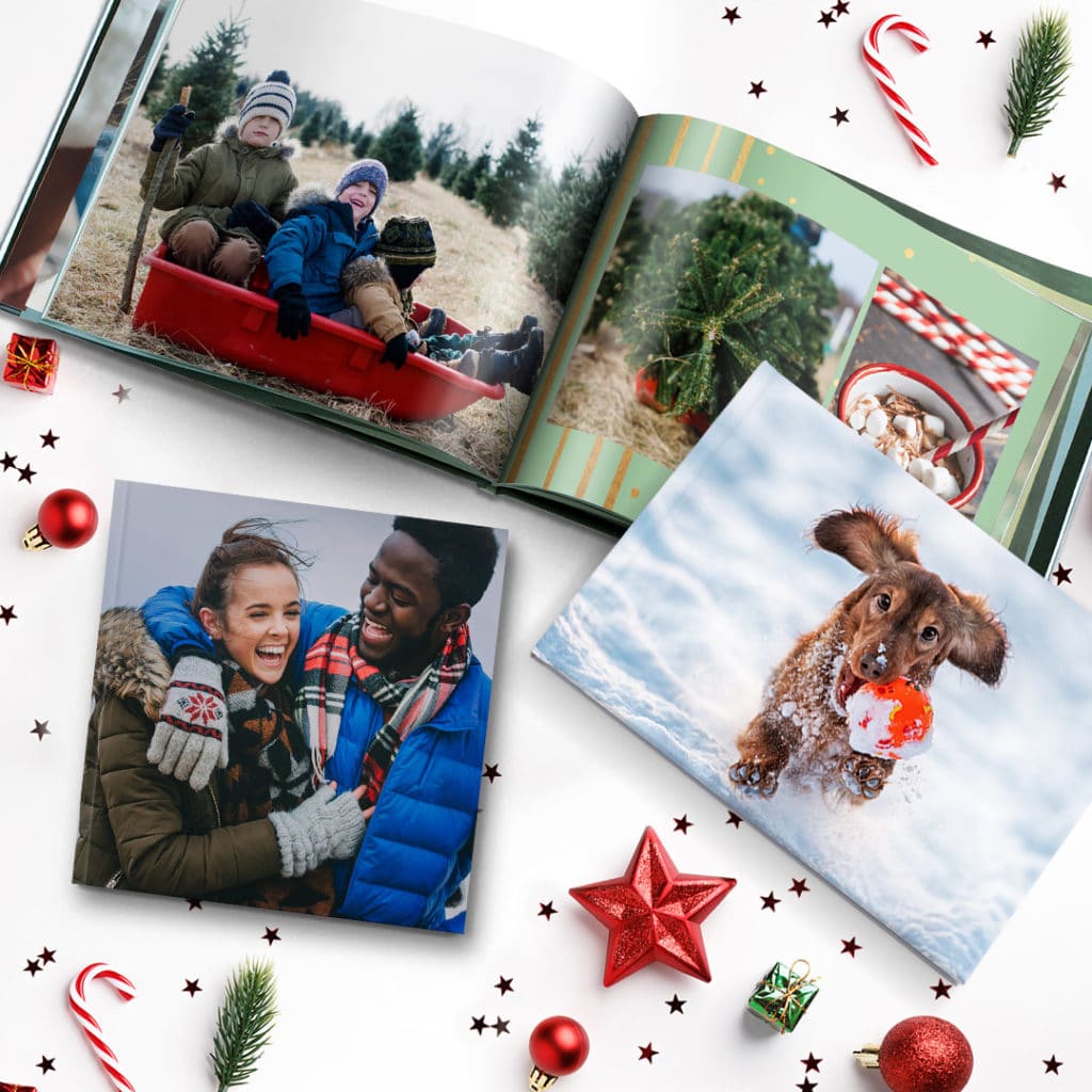 3 sized photobooks surrounded by christmas decor