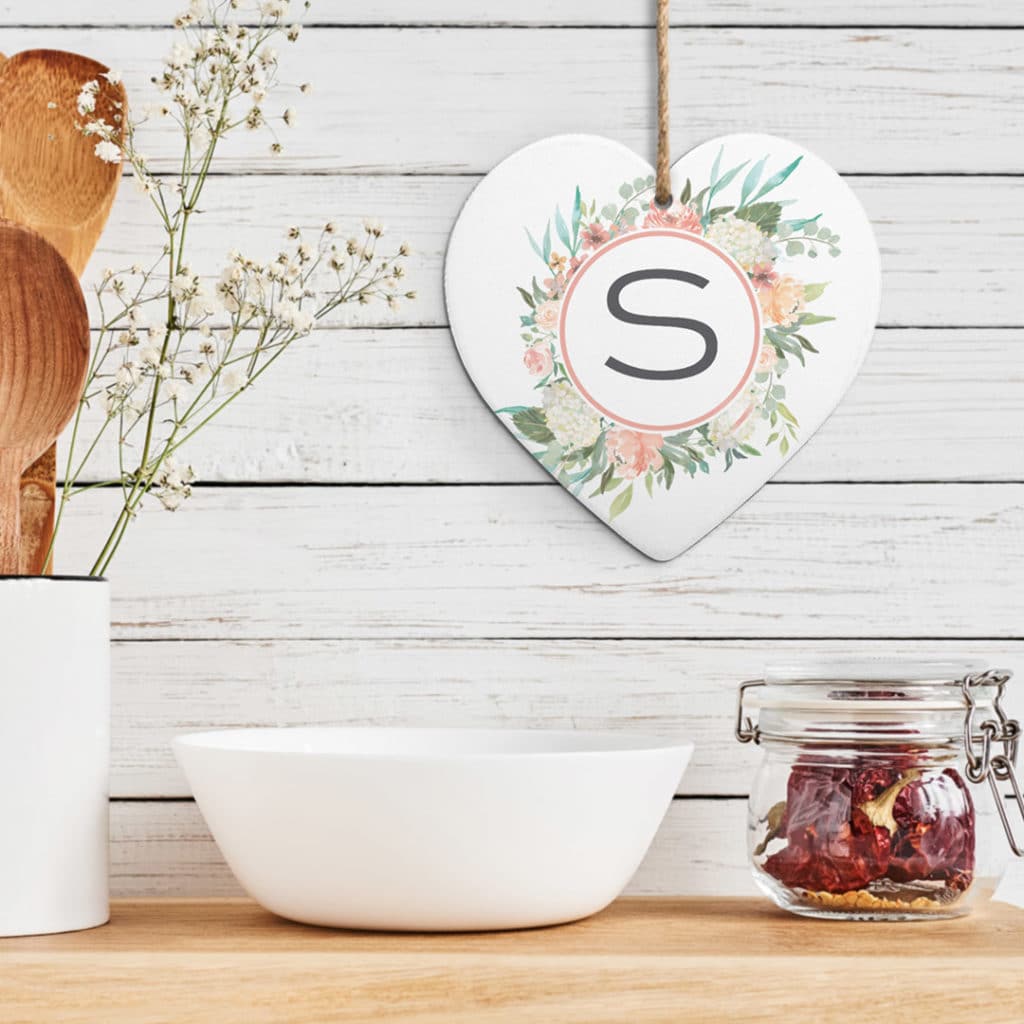 customized floral heart trivet hanging off wall behind kitchen counter