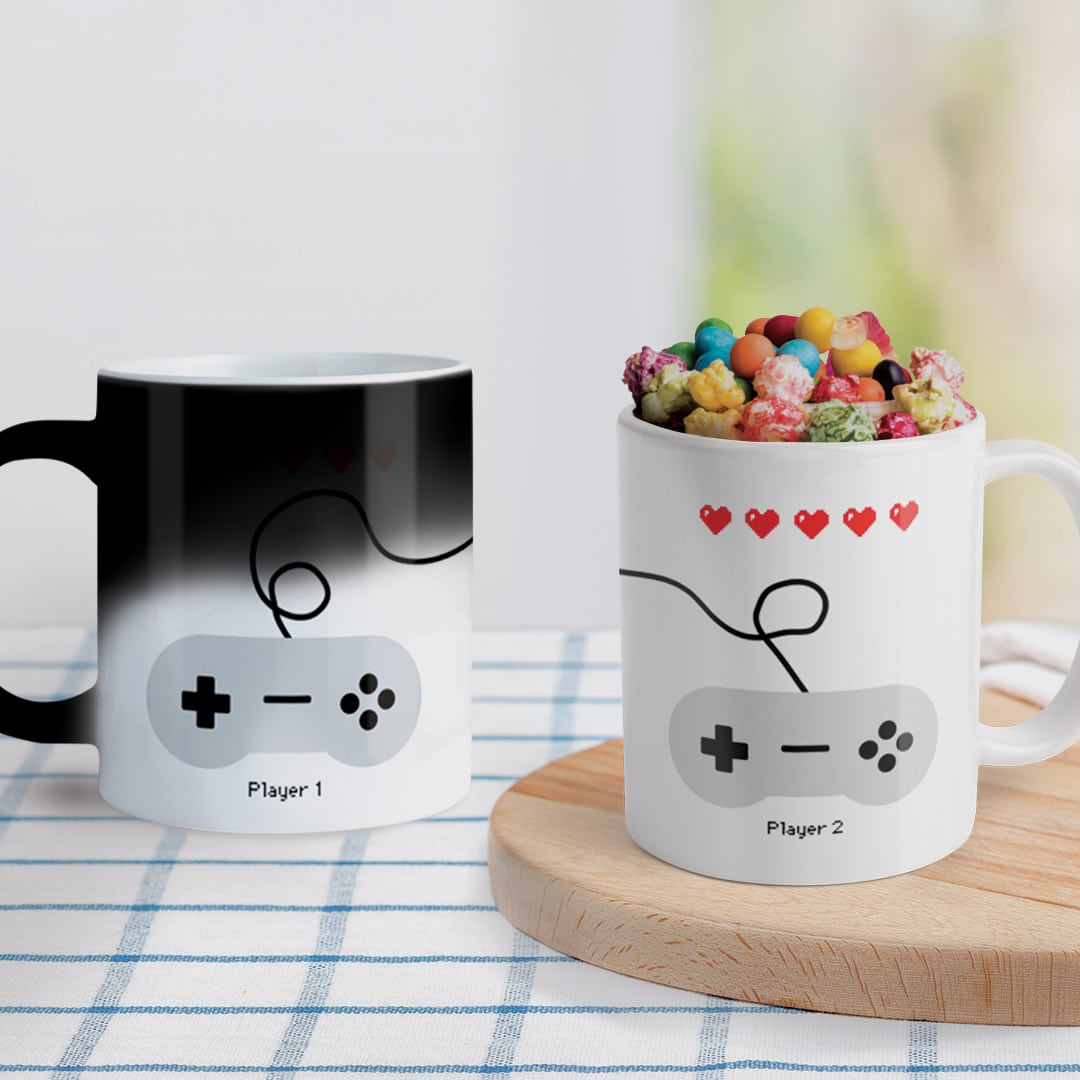 player one and player two mugs, one with candy inside