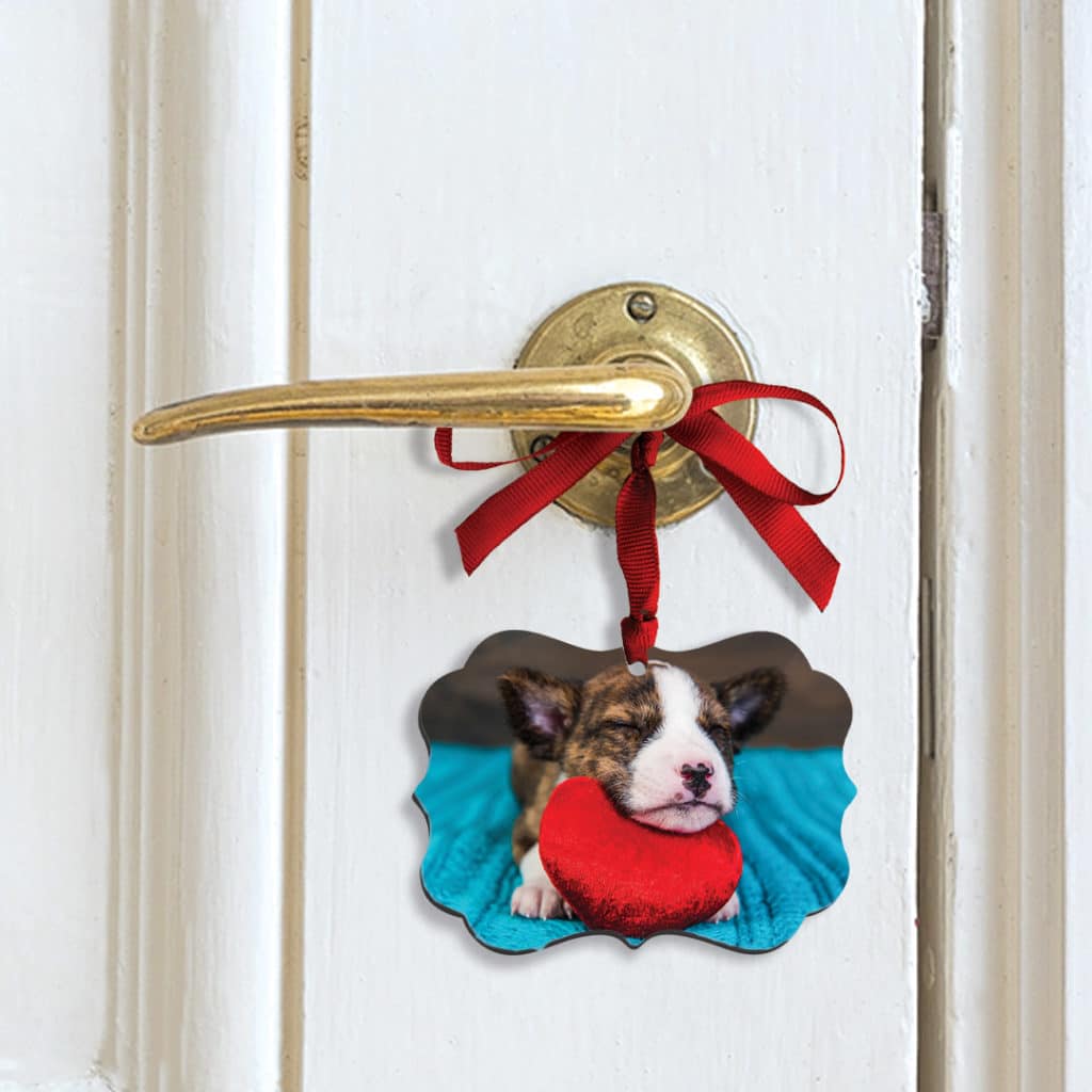 Ornament of puppy hanging on door handle