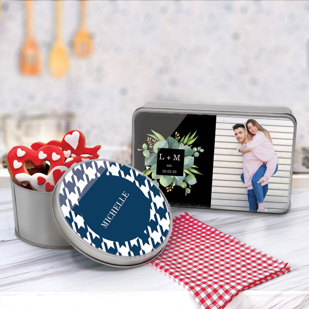 personalised metal tins on a counter top with valentine cookies inside