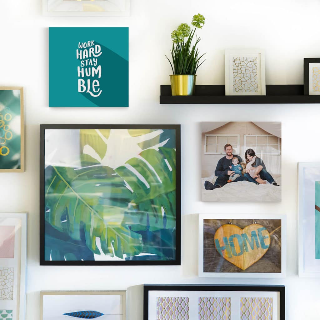 Create an asymmetrical wall display with a mixture of photo tiles and framed prints