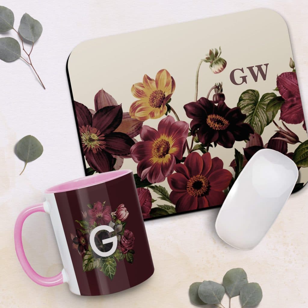 A personalised mousemat and mug shown laying on a table