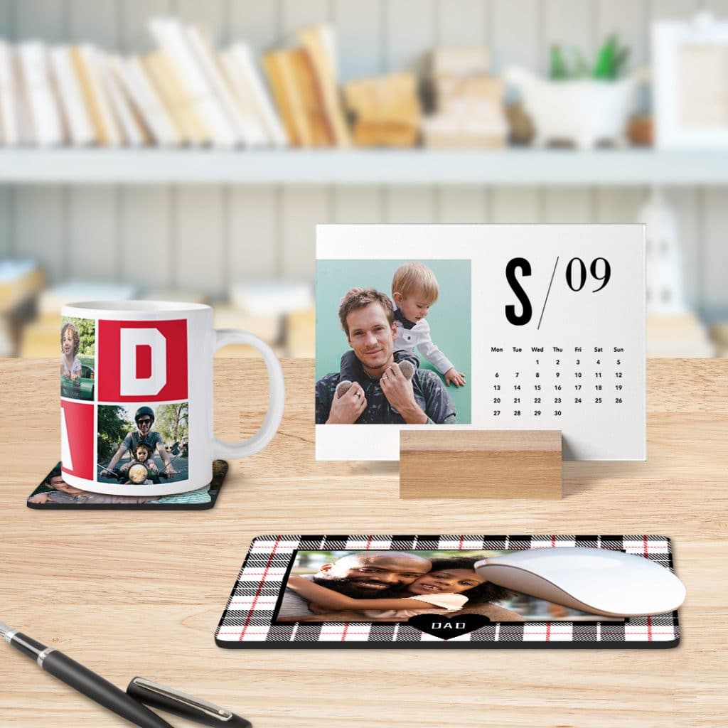 A mug, coaster, woodblock calendar and mousemat displayed on a desk