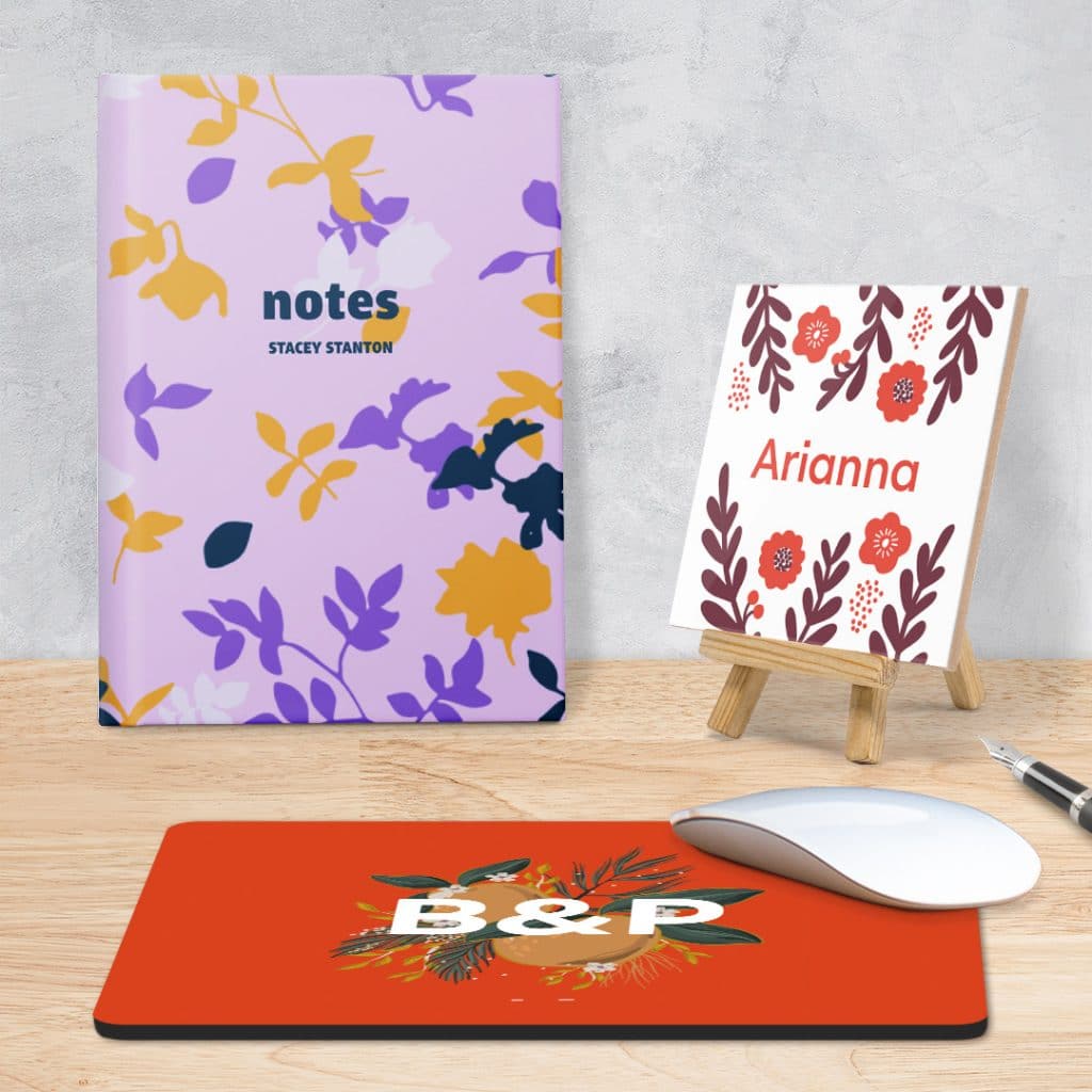 A personalised notebook, ceramic photo tile and mousemat with floral designs