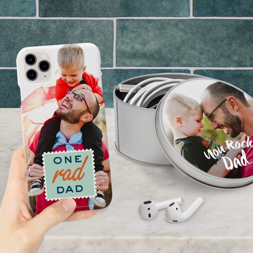 Mobile phone case and a round personalised tin containing charging cables