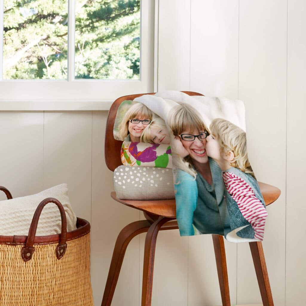 folded blankets on chair next to window