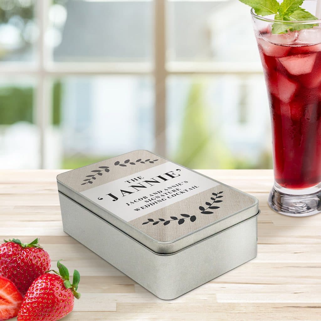 A personalised tin alongside cocktails