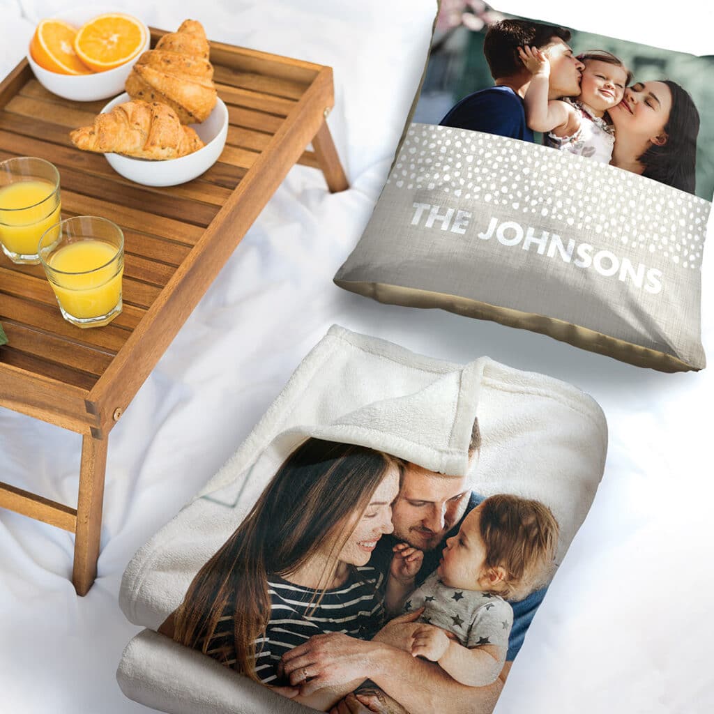 cushion and blanket on a bed with breakfast tray