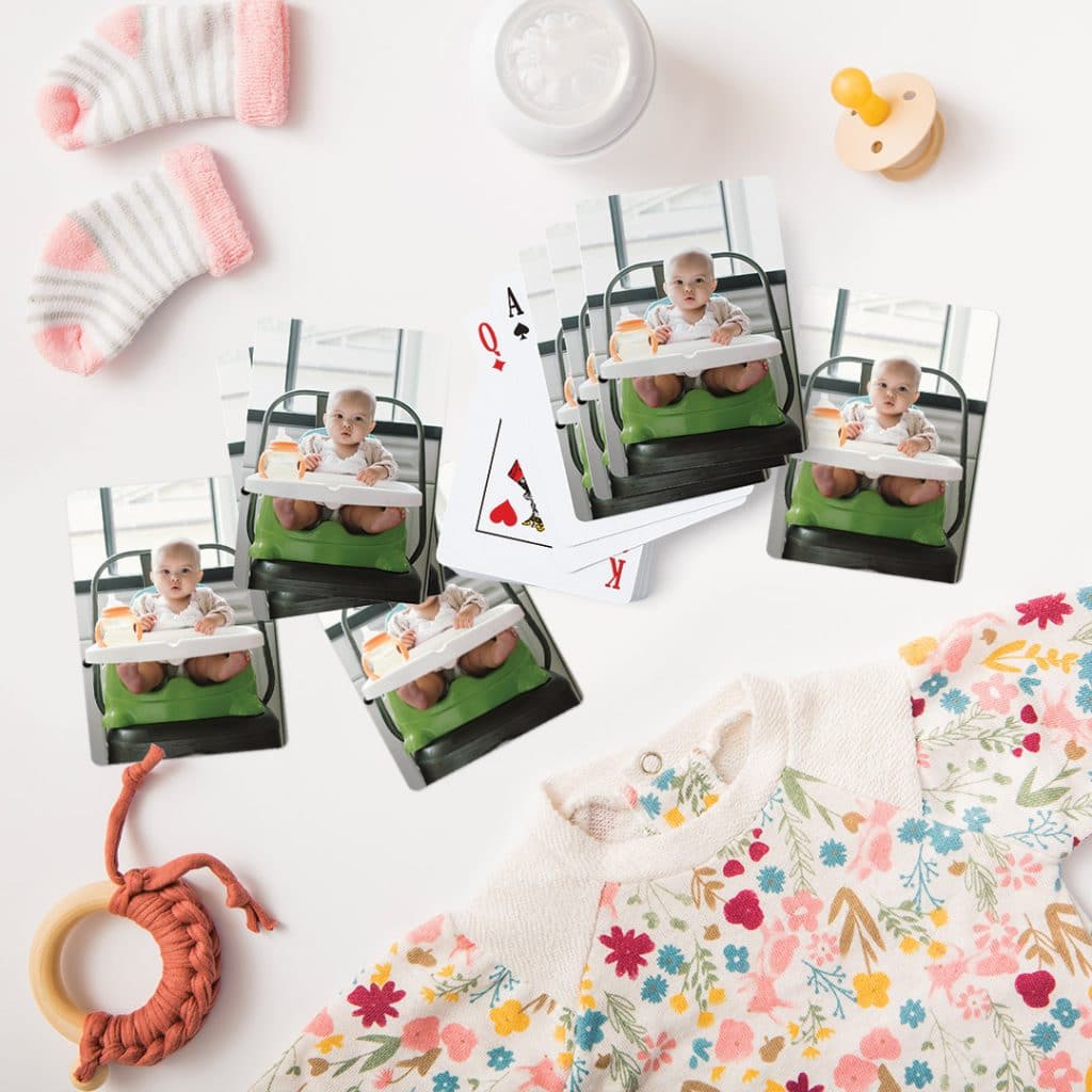 photo playing cards with surrounded by baby things