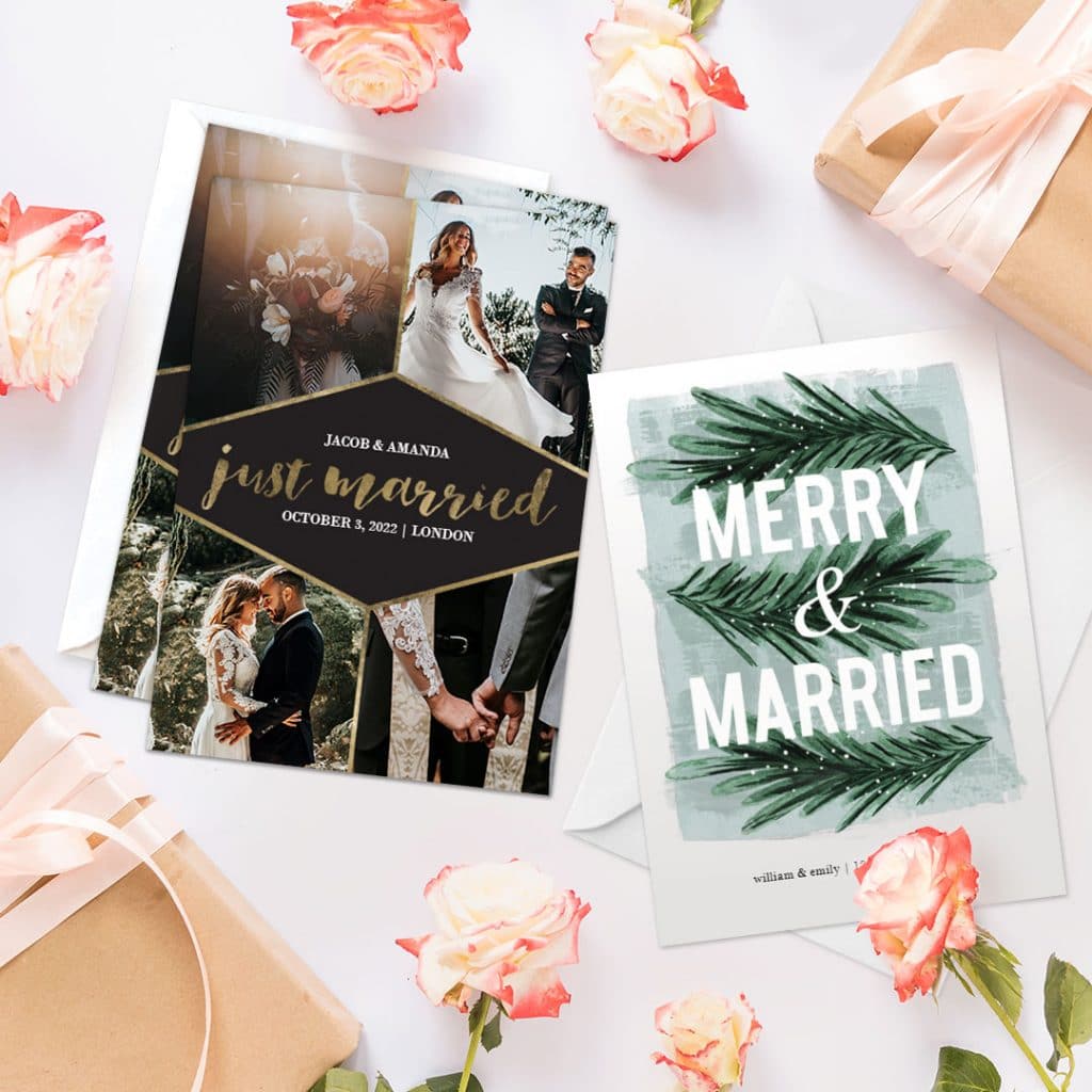 Wedding announcement cards displayed on a surface with orange roses and gift boxes