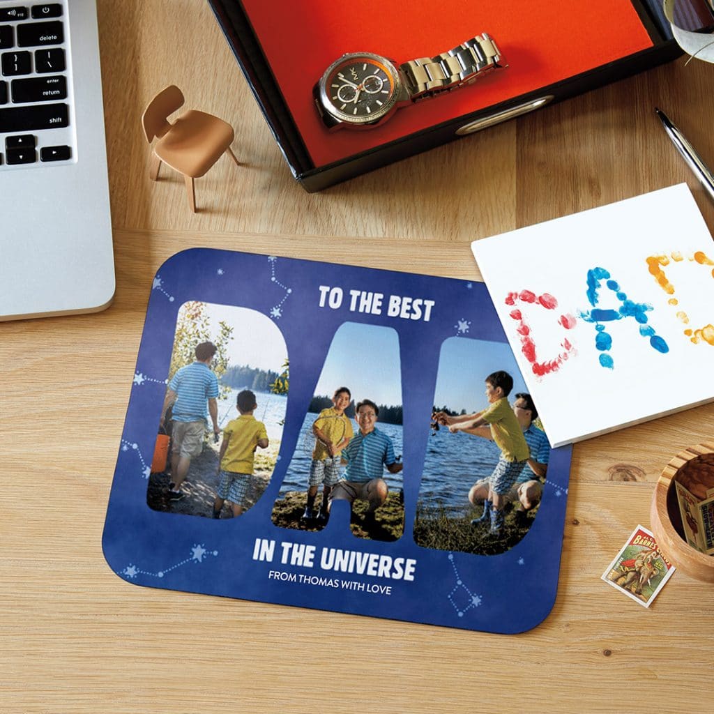 Custom mousemat design with a father/son collage in letters spelling Dad next to laptop