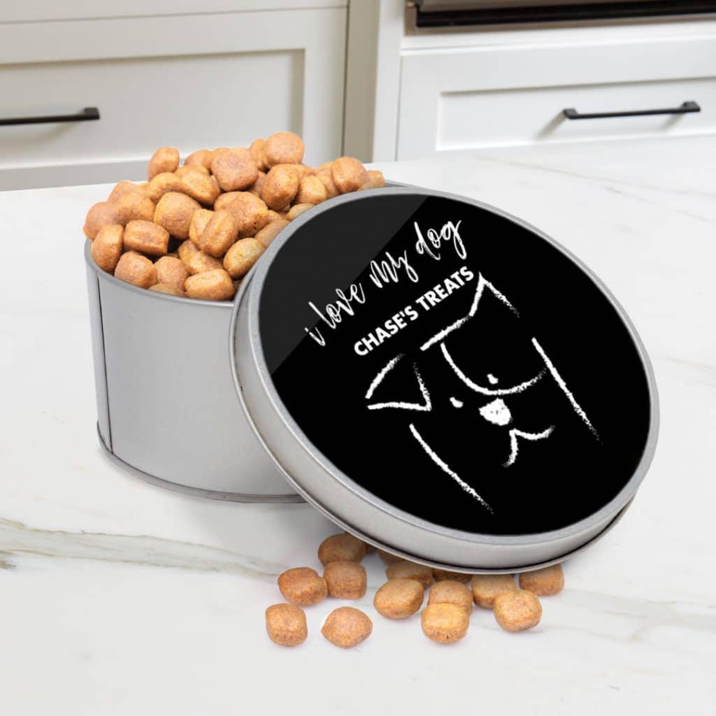 circular tin on table full of dog treats and personalised with custom text on lid
