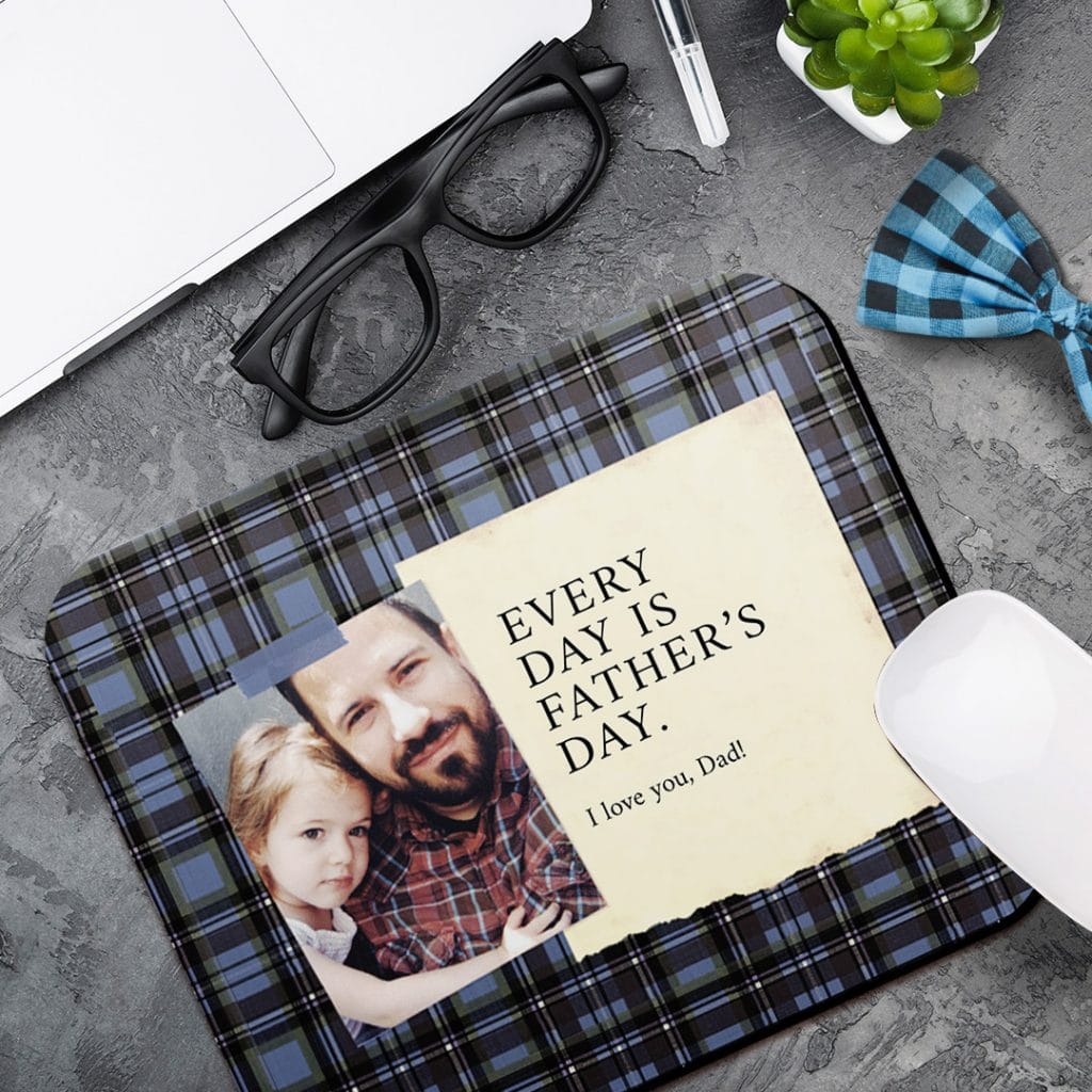 Photo mousemat with plaid design showing a note from daughter next to laptop