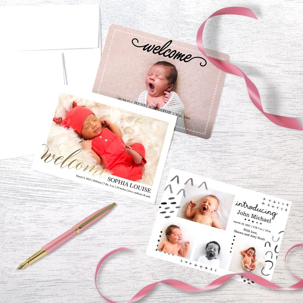 3 different baby announcements laying on a table