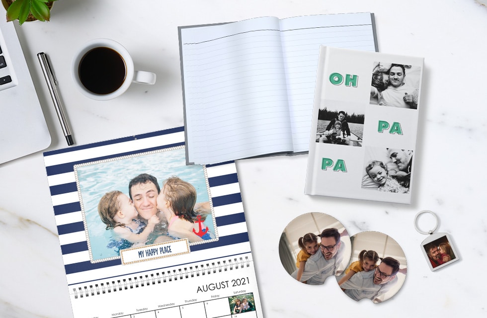 Calendar, notebook, keychain, and car coasters decorated with photos of a dad and his daughters