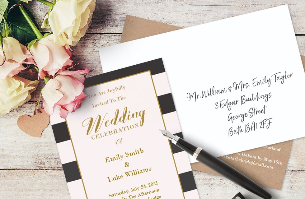 A set of wedding invitation cards and addressed envelopes