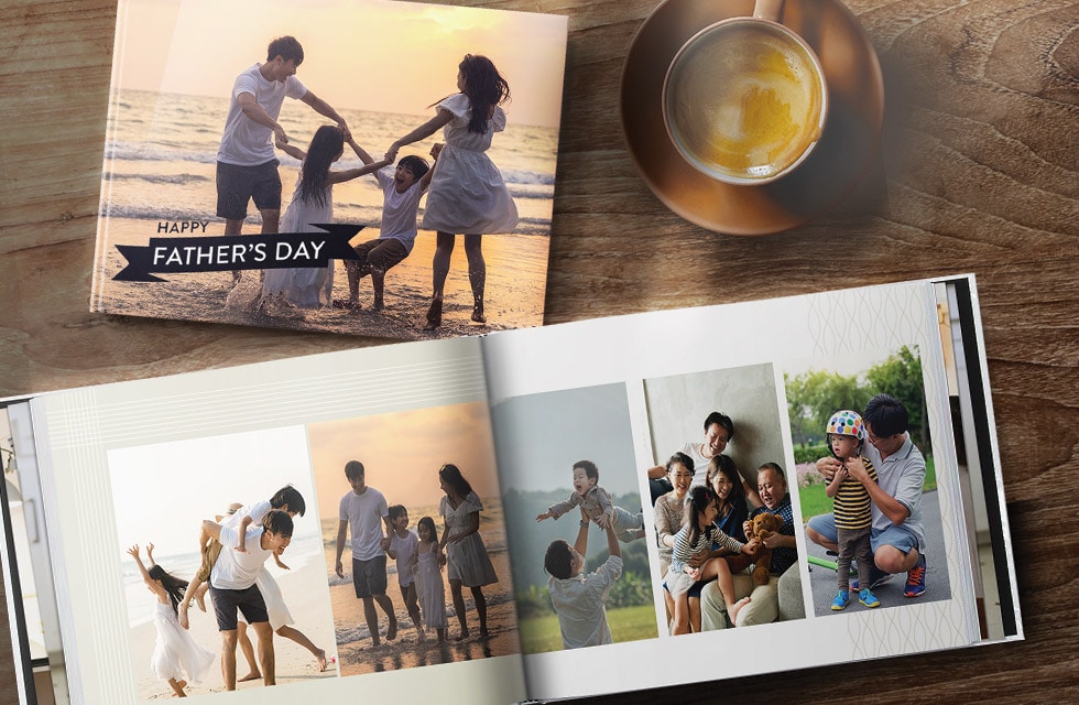 Closed and open Father's Day photo book top view next to cup of coffee