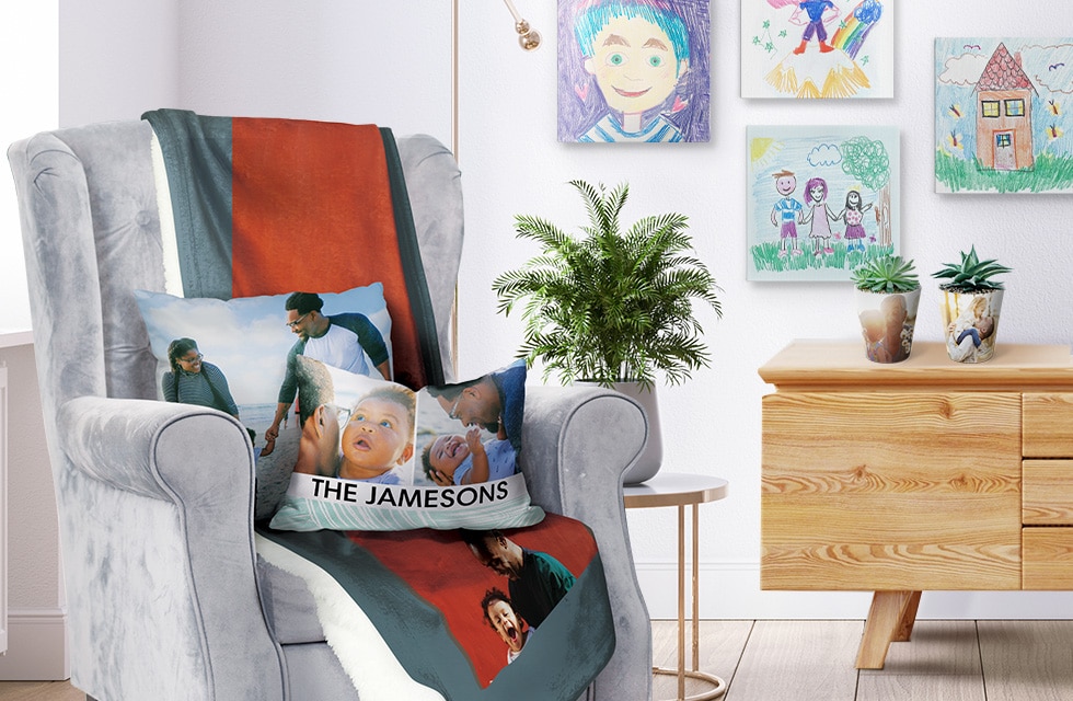 Selection of Father's Day gifts: photo cushion on chair, with plant pots and foam tiles in the background