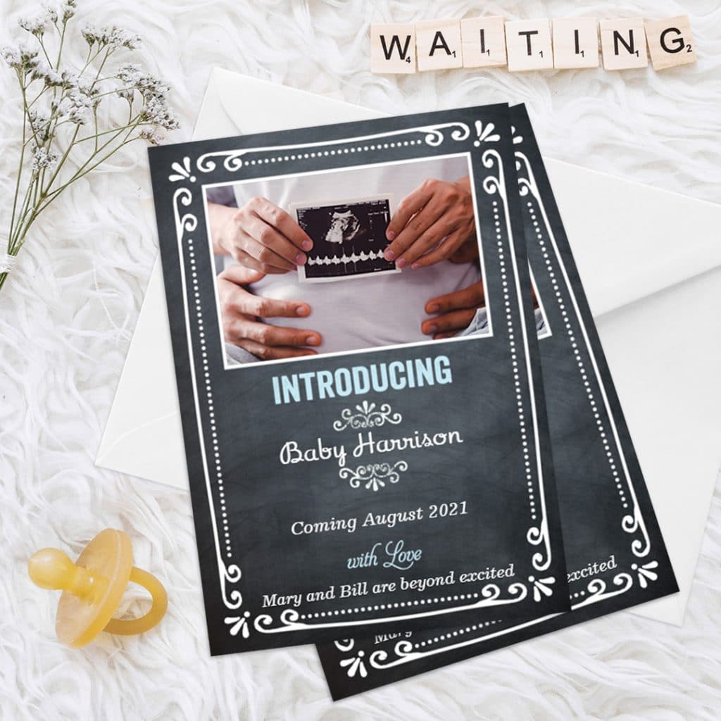 Introducing new baby card presented on a white furry rug