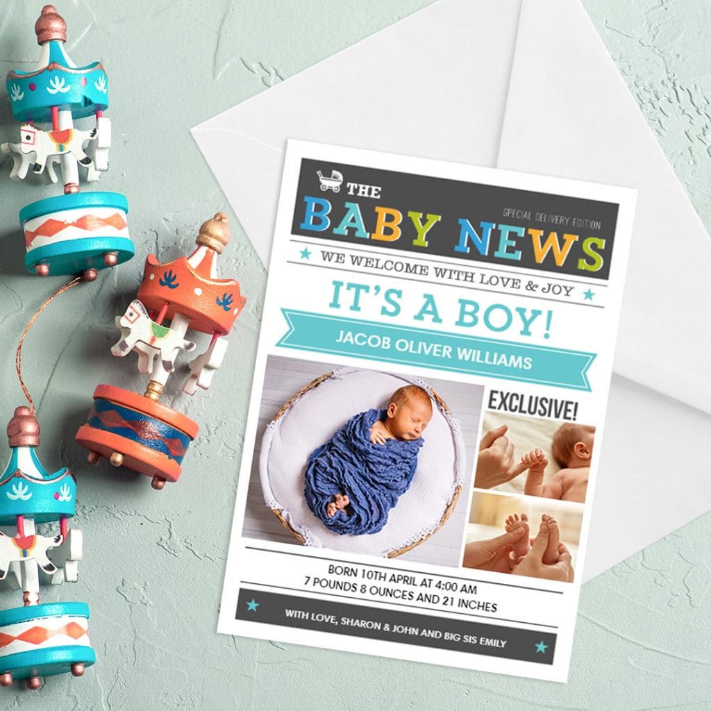 It's a boy, custom birth announcement card and envelope placed next to baby toys