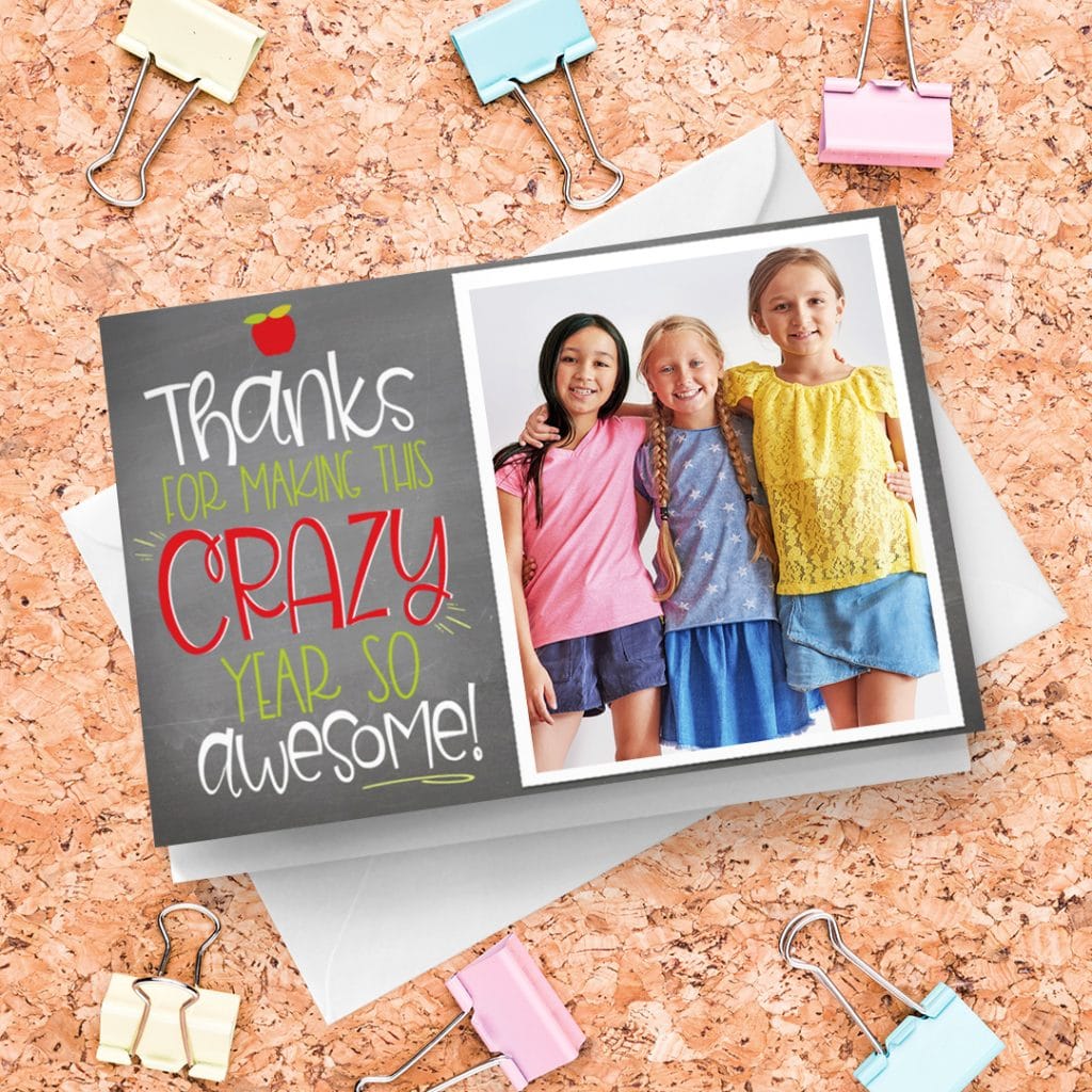 A teacher thanks card with an image of three little girls, presented on a soft board