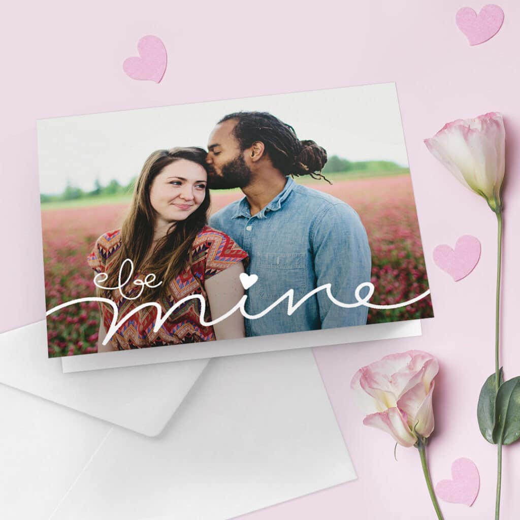 A Valentines Day greeting card with a happy couple image and text - be mine